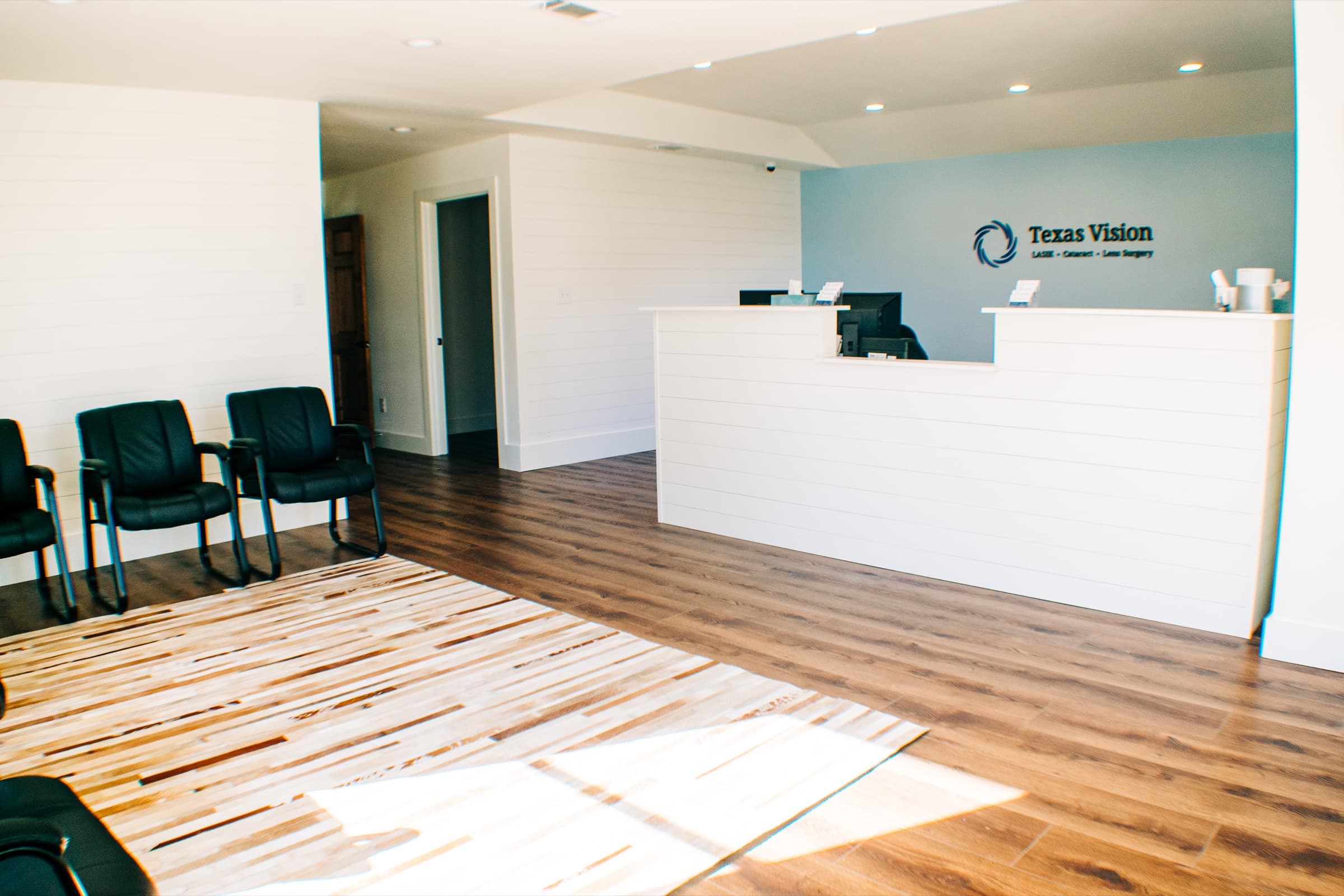 The Georgetown reception desk, branded with the Texas Vision logo