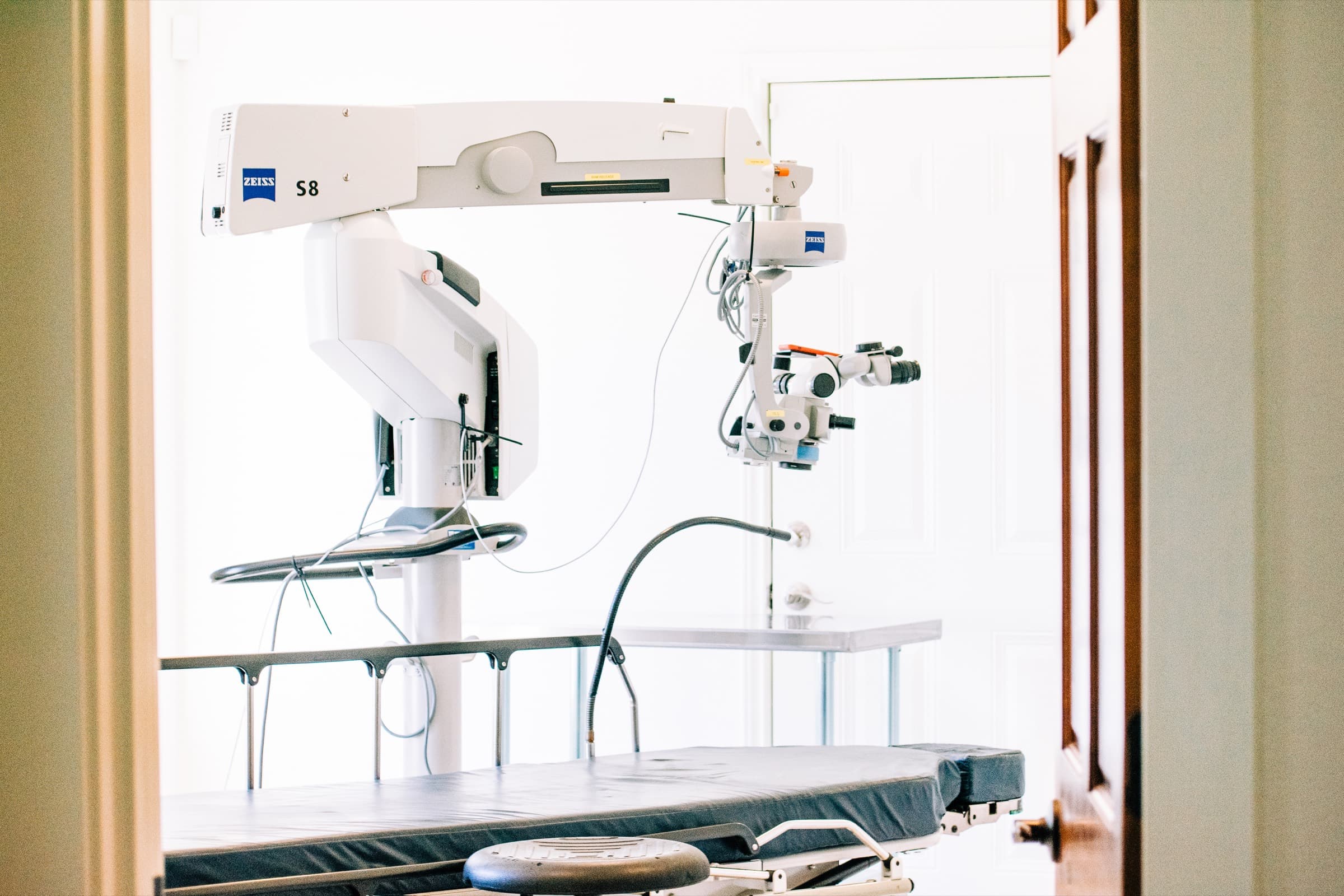 A surgical microscope over the operating table in the Georgetown in-office surgical suite
